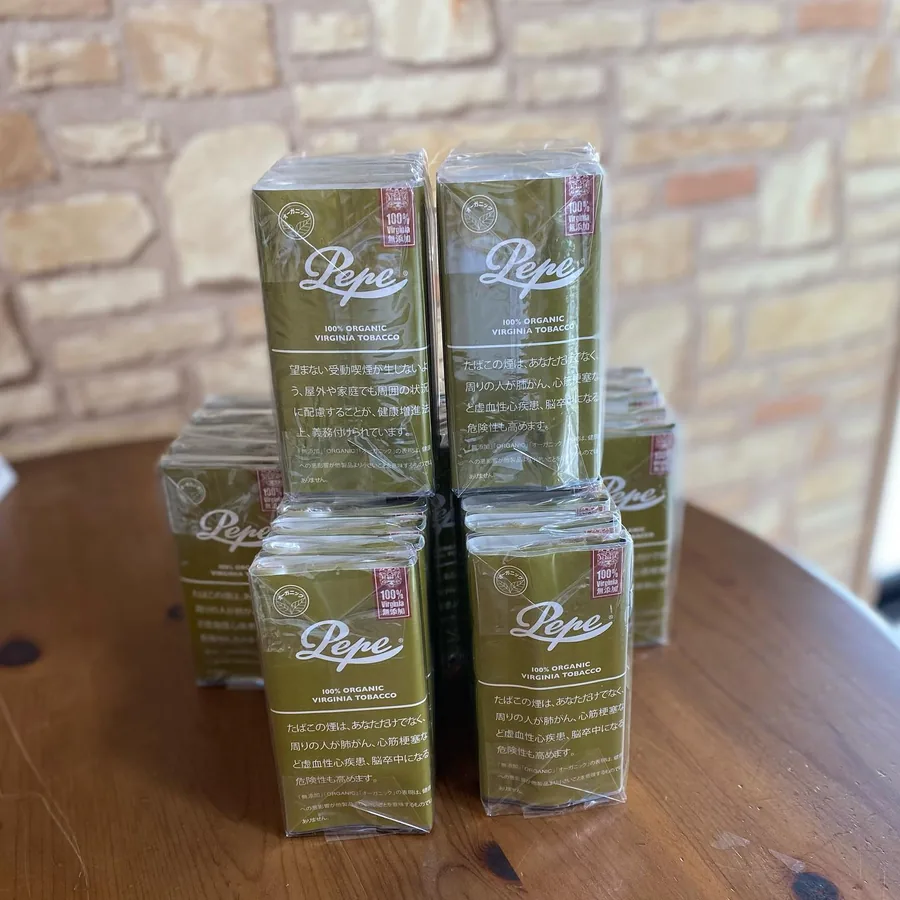 나무 테이블 위에 쌓인 Pepe 100% Organic Virginia Tobacco 파우치 — Himawari Tobacco Shop, Tsuruga
